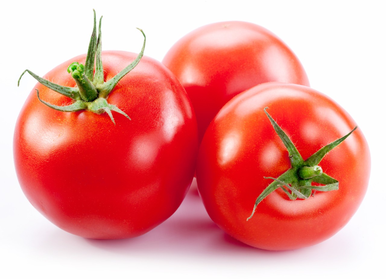 Ripe red tomatoes isolated on a white background.